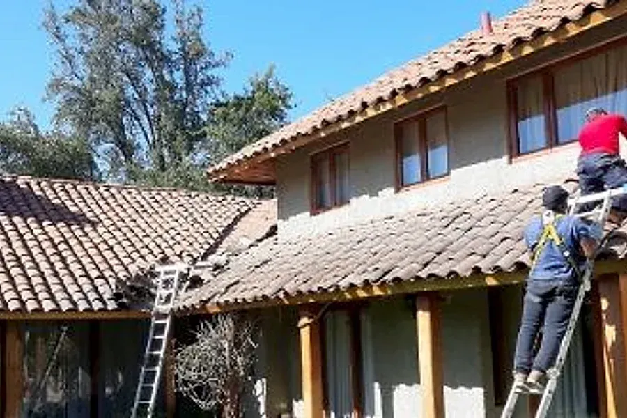 Trabajadores de Techos León en un techo de teja de arcilla (teja chilena) en El Melocotón